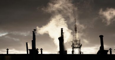 silhouette of factory under cloudy sky