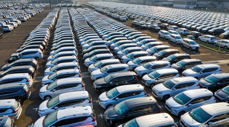 rows of expensive modern cars on asphalt parking of manufacture