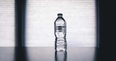 clear disposable bottle on black surface