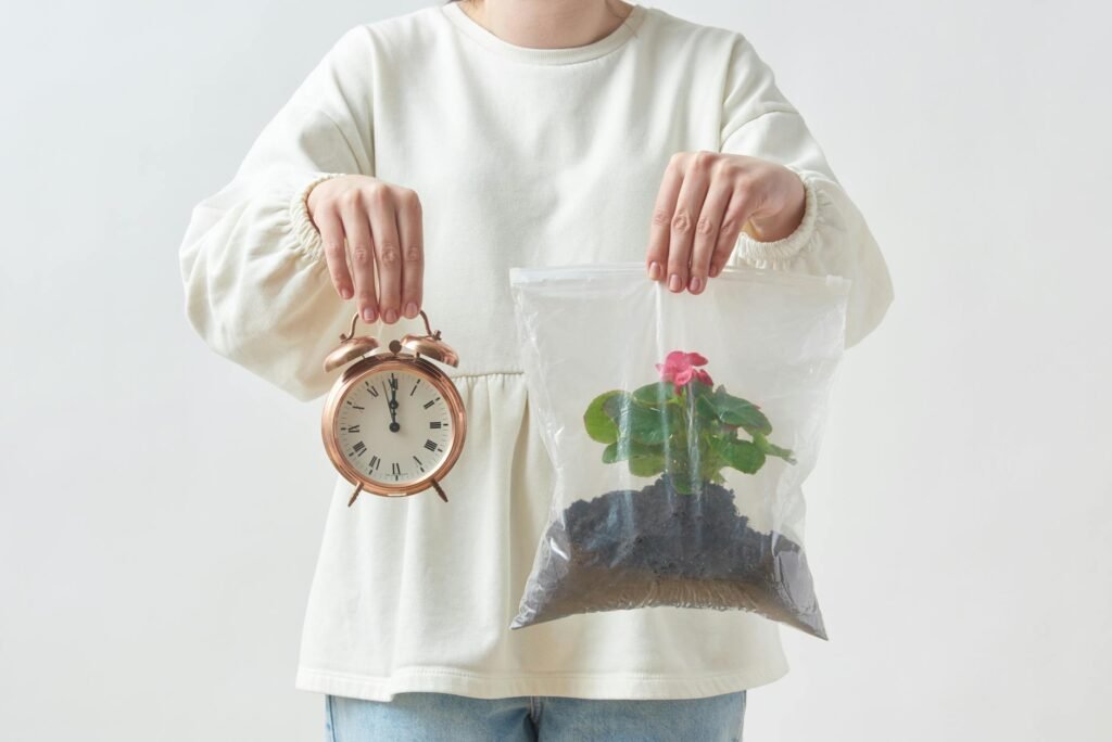 woman holding a clock and a plant in plastic bag