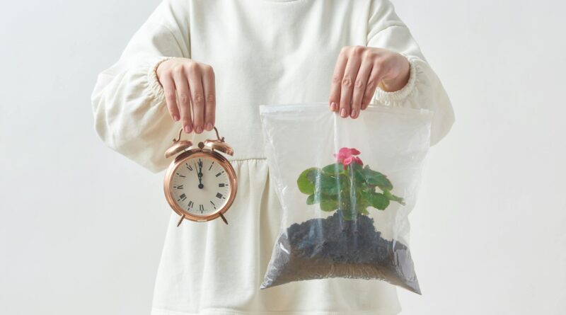 woman holding a clock and a plant in plastic bag