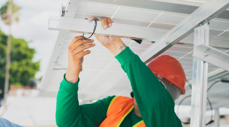 construction worker holding on a purlin