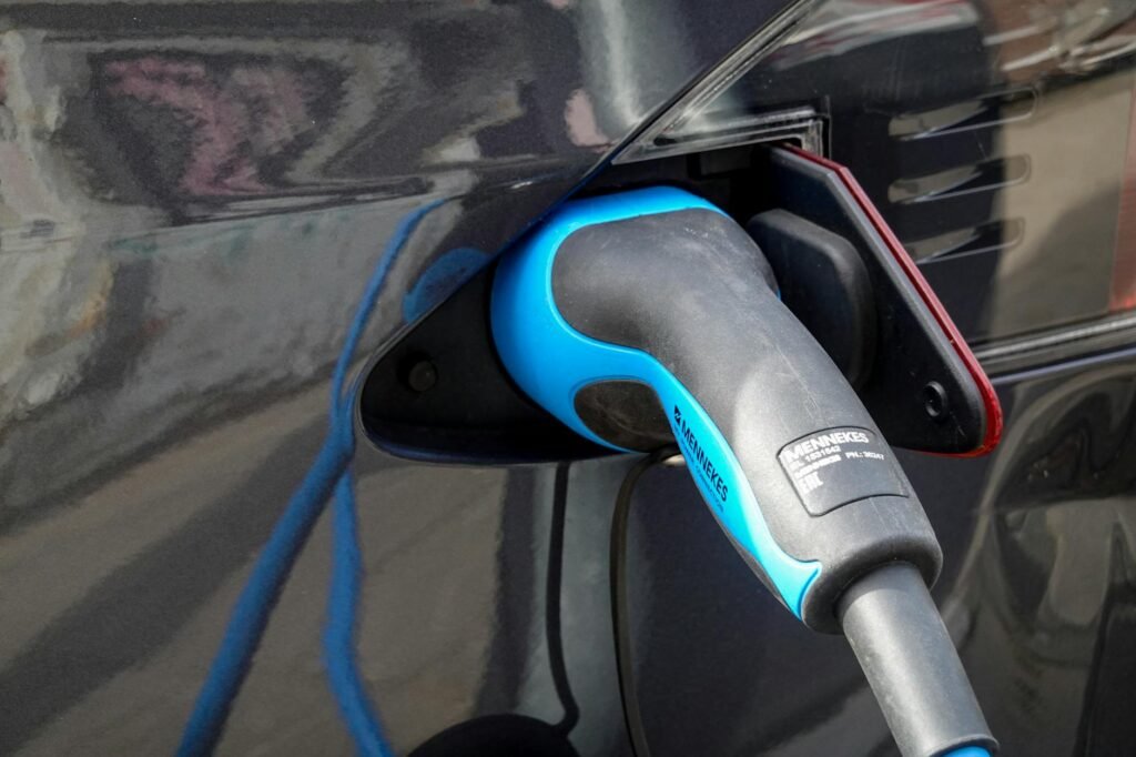 a blue and black gas pump nozzle in a vehicle gas tank