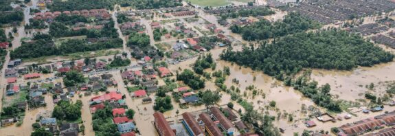 flooded town with residential buildings and trees