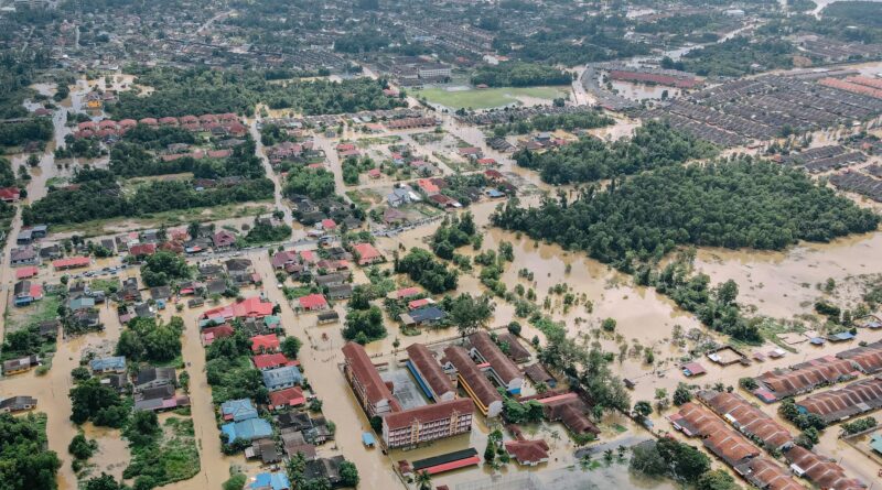flooded town with residential buildings and trees