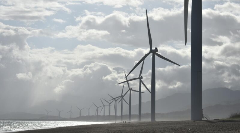 windmills on seashore under white clouds
