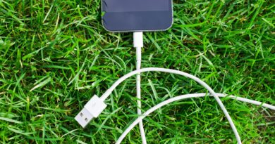 black ipod touch and cable on grass