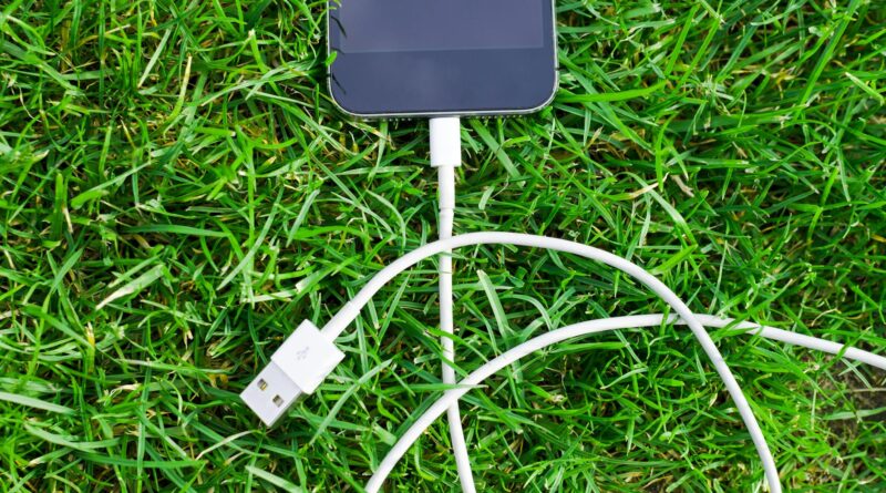 black ipod touch and cable on grass
