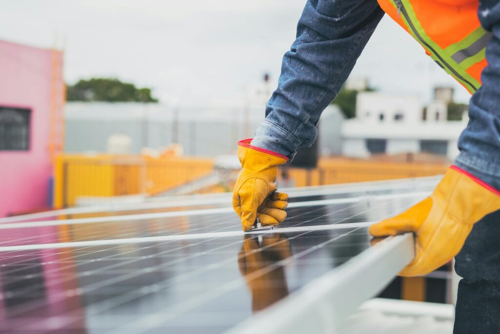 selective focus on maintenance man installing solar panel
