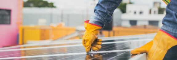selective focus on maintenance man installing solar panel