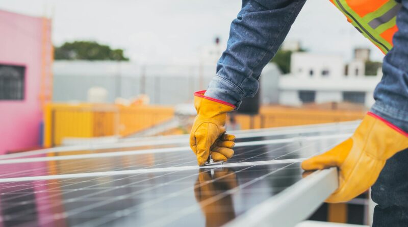 selective focus on maintenance man installing solar panel