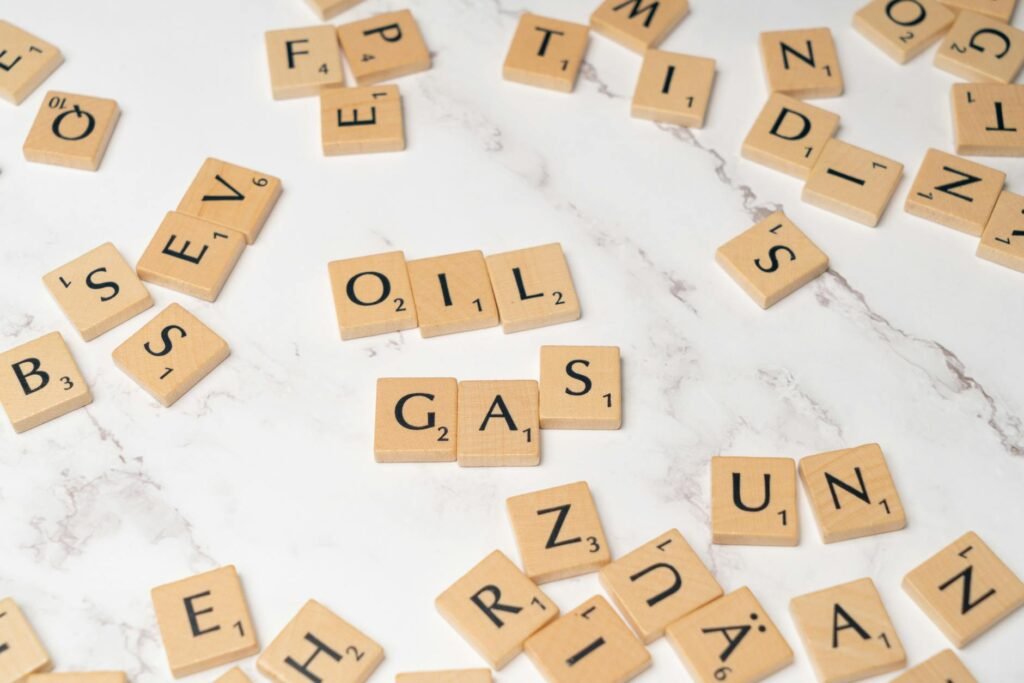 scrabble letters spelling out oil and gas