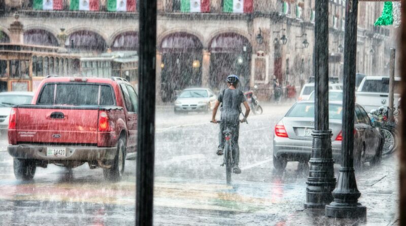 person riding a bicycle during rainy day