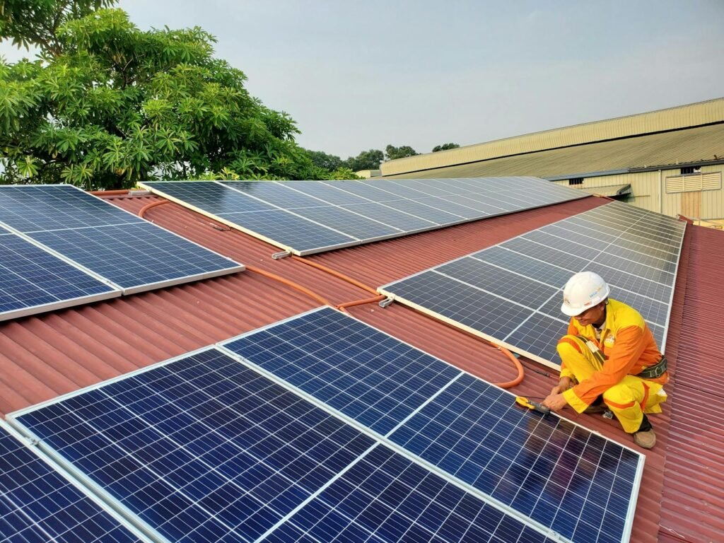a male solar technician installing a solar panel