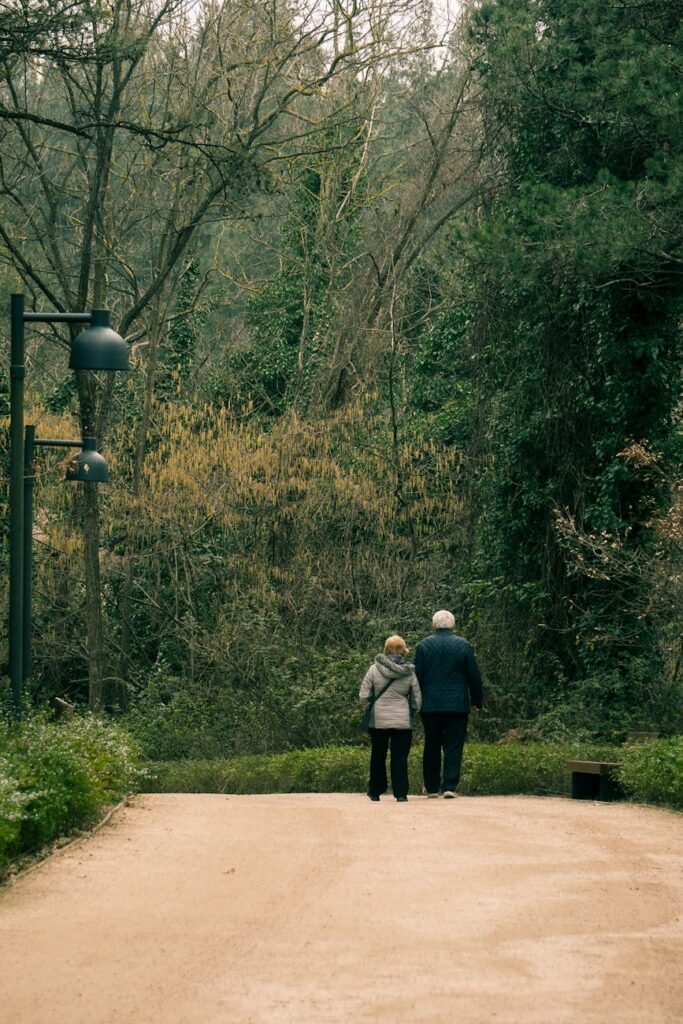 elderly couple walking at park