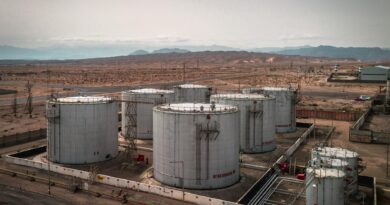 aerial view of industrial oil tanks in desert landscape