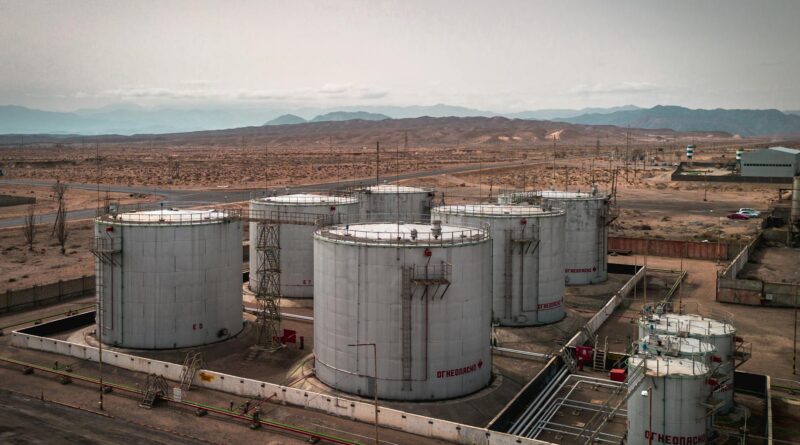 aerial view of industrial oil tanks in desert landscape