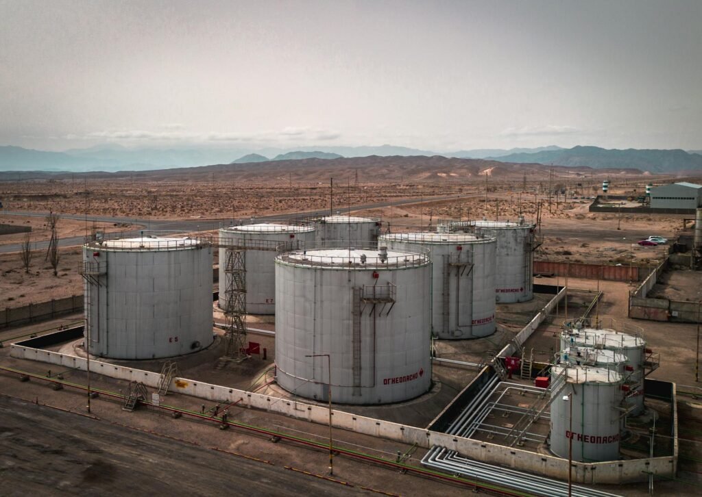 aerial view of industrial oil tanks in desert landscape