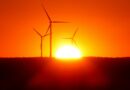 silhouette of wind turbines at sunset