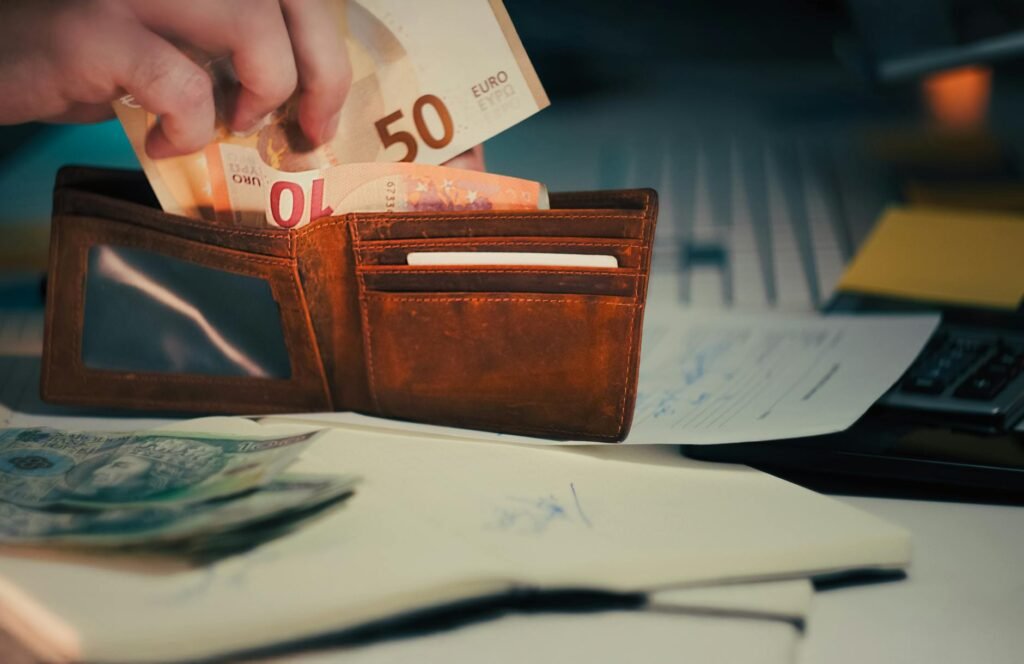 wallet with euro banknotes on office desk