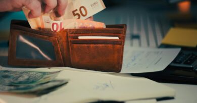 wallet with euro banknotes on office desk