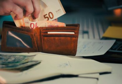 wallet with euro banknotes on office desk