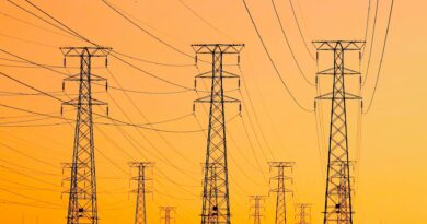 high voltage transmission towers at sunset