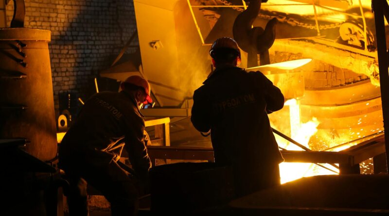 men in helmet standing beside steel melting pool