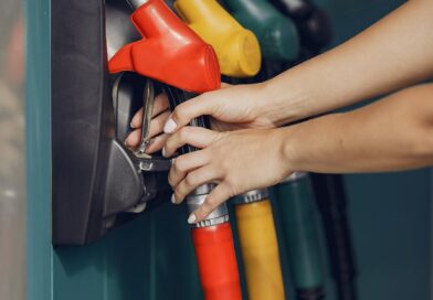 crop woman taking refueling pistol gun