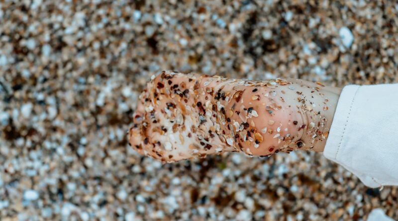 brown and white stone fragments on a person s bare foot