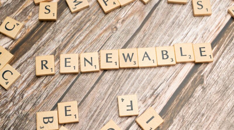the word renewable written in scrabble letters on a wooden table