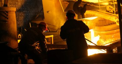 men in helmet standing beside steel melting pool