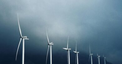 white wind turbines under white clouds