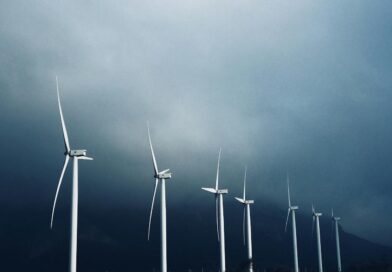 white wind turbines under white clouds
