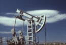 a gray steel pumpjack under blue sky