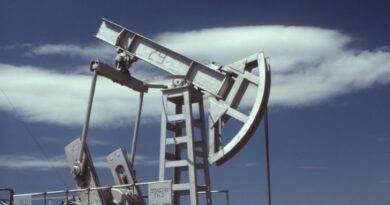 a gray steel pumpjack under blue sky