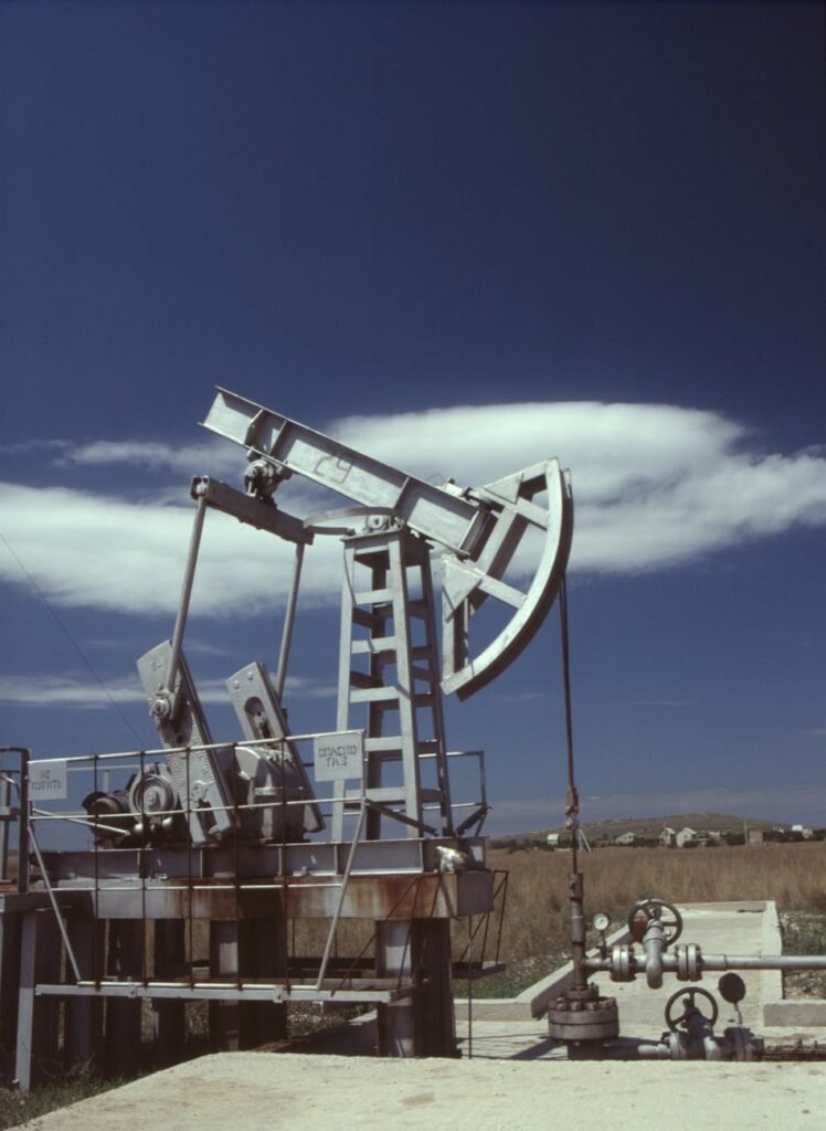 a gray steel pumpjack under blue sky