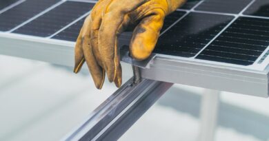 person s hand on top of solar panel