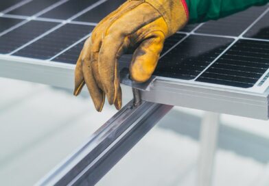 person s hand on top of solar panel