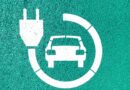 an electric car icon on a green wall