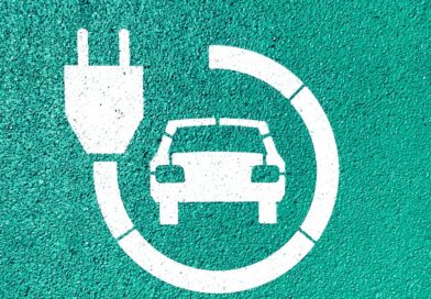 an electric car icon on a green wall
