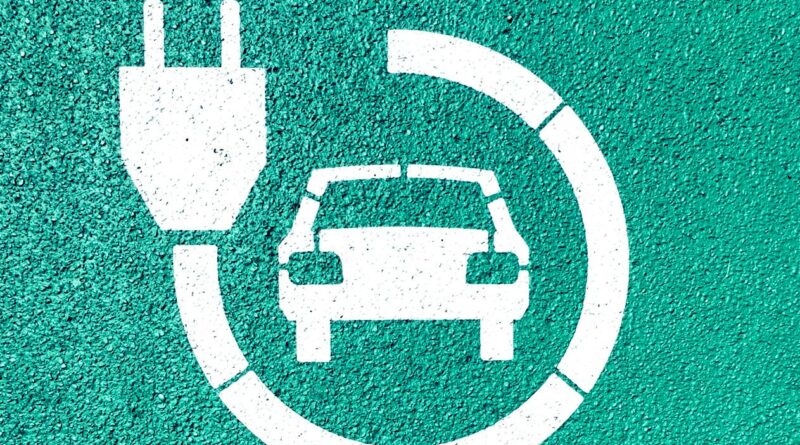 an electric car icon on a green wall