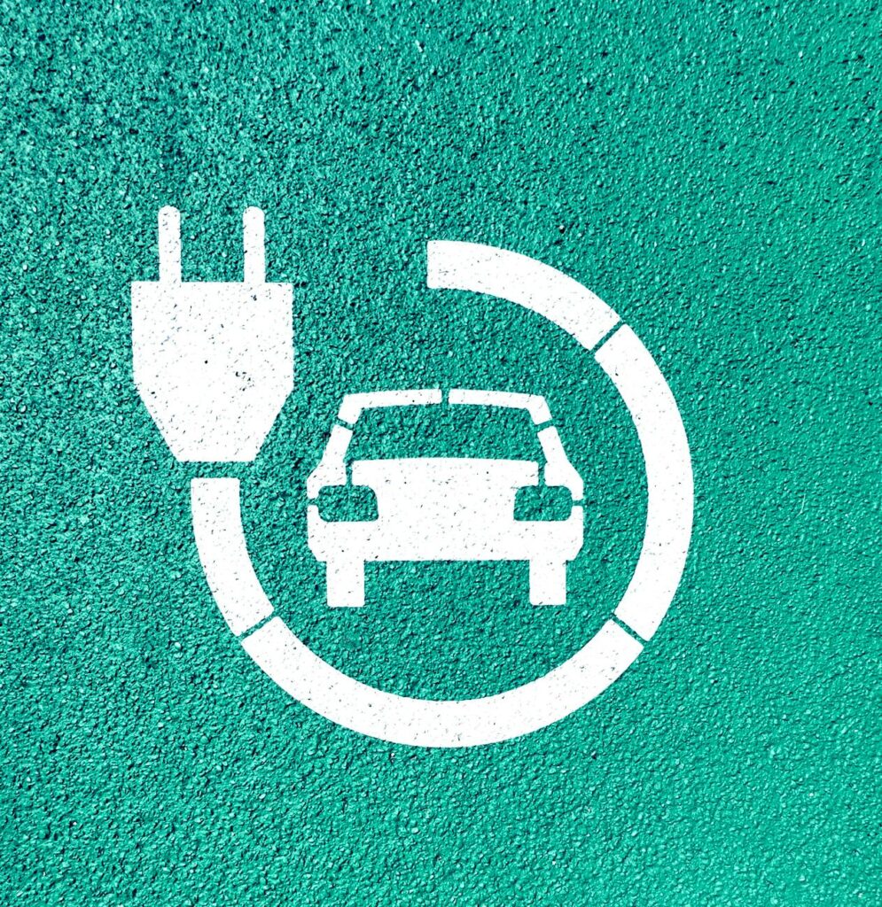 an electric car icon on a green wall