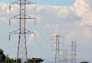 rural landscape with electric pylons and cloudy sky