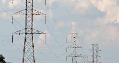 rural landscape with electric pylons and cloudy sky