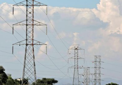 rural landscape with electric pylons and cloudy sky