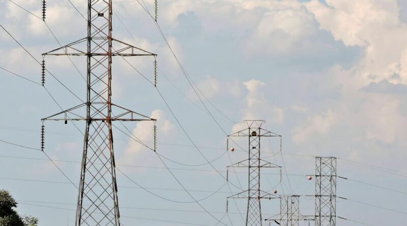 rural landscape with electric pylons and cloudy sky
