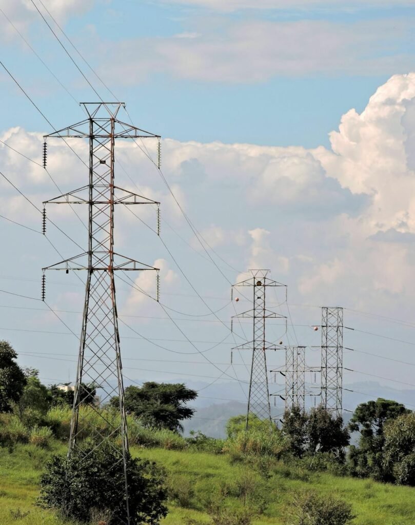 rural landscape with electric pylons and cloudy sky