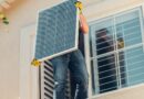 a man carrying solar panel