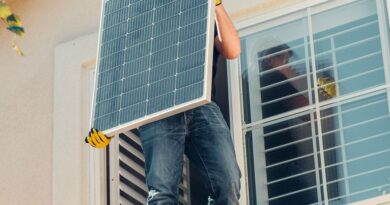 a man carrying solar panel
